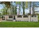 Charming renovated home with a well-manicured lawn, painted white brick, and stylish black trim at 307 Gordon Woods Sw Dr, Mableton, GA 30126