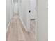 Bright hallway with light wood floors and white walls, leading to various rooms at 307 Gordon Woods Sw Dr, Mableton, GA 30126