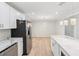 Kitchen area with stainless steel appliances, white cabinets, a kitchen island and sleek pendant lighting at 307 Gordon Woods Sw Dr, Mableton, GA 30126
