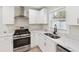 Upgraded kitchen with stainless steel appliances, gas range, white cabinets, and modern faucet at 307 Gordon Woods Sw Dr, Mableton, GA 30126