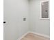 Simple laundry room with light wood-look flooring and fresh, white walls at 307 Gordon Woods Sw Dr, Mableton, GA 30126