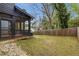 Fenced backyard featuring a screened porch and a well-maintained lawn with stone landscaping at 3172 Chapel St, Scottdale, GA 30079