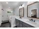 Bright bathroom features double vanity with black fixtures and a walk-in shower with tiled walls at 3172 Chapel St, Scottdale, GA 30079