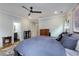 Cozy bedroom with decorative ceiling fan, hard wood floors, and attached bathroom and closet at 3172 Chapel St, Scottdale, GA 30079