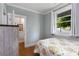Charming bedroom featuring hardwood floors, natural light, and a view of the peaceful neighborhood at 3172 Chapel St, Scottdale, GA 30079