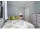 Cozy bedroom with soft colors, bright natural light, and a matching bedside table and dresser at 3172 Chapel St, Scottdale, GA 30079