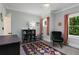 Inviting ' room with colorful rug and two windows bringing in lots of natural light at 3172 Chapel St, Scottdale, GA 30079