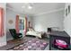 Bright bedroom with colorful rug, rocking chair, and window bringing in natural light at 3172 Chapel St, Scottdale, GA 30079