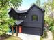 Modern two-story home with a welcoming porch, an attached garage, and a vibrant coral front door at 3172 Chapel St, Scottdale, GA 30079