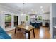 Open-concept kitchen and dining area with stainless steel appliances and a cozy view into the backyard at 3172 Chapel St, Scottdale, GA 30079