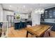 Modern kitchen with stainless steel appliances, granite countertops, pendant lights, and dining table at 3172 Chapel St, Scottdale, GA 30079
