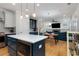 Open-concept kitchen features stainless appliances and flows into a cozy living area with modern furniture at 3172 Chapel St, Scottdale, GA 30079