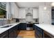 Modern kitchen with stainless steel appliances, grey backsplash, and two-tone cabinets at 3172 Chapel St, Scottdale, GA 30079