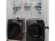 Convenient laundry room equipped with modern washer and dryer and ample storage shelving for an organized space at 3172 Chapel St, Scottdale, GA 30079