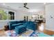 Bright and spacious living room featuring a large sectional sofa and seamless flow into the modern kitchen at 3172 Chapel St, Scottdale, GA 30079