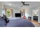 Well-lit main bedroom with TV, large windows, and bathroom entrance at 3172 Chapel St, Scottdale, GA 30079