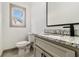 Half bathroom with granite countertops, a toilet, and modern fixtures at 400 Stone Lea Trce, Oxford, GA 30054