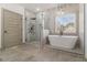 Luxurious bathroom featuring a freestanding tub and glass-enclosed shower at 400 Stone Lea Trce, Oxford, GA 30054