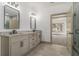 Stylish bathroom with double vanity and a doorway leading to the bedroom at 400 Stone Lea Trce, Oxford, GA 30054