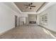 Large bedroom featuring a fireplace, tray ceiling, and lots of natural light at 400 Stone Lea Trce, Oxford, GA 30054