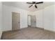 Bedroom features neutral carpet, a ceiling fan, and two doors at 400 Stone Lea Trce, Oxford, GA 30054