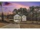 Two-story modern farmhouse with black trim and lush trees at 400 Stone Lea Trce, Oxford, GA 30054