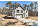 Modern farmhouse exterior with a two-car garage and well-manicured lawn at 400 Stone Lea Trce, Oxford, GA 30054