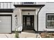 Close-up of front door with a black frame, decorative sidelights, and modern house numbers at 400 Stone Lea Trce, Oxford, GA 30054