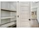 Hallway featuring built-in shelving and access to other rooms with bright lighting and modern finishes at 400 Stone Lea Trce, Oxford, GA 30054
