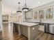 Open-concept kitchen with island featuring granite countertops, stainless steel appliances, and easy access to living area at 400 Stone Lea Trce, Oxford, GA 30054