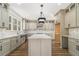 Spacious kitchen features a large island, granite countertops, custom cabinets, and stainless steel appliances at 400 Stone Lea Trce, Oxford, GA 30054