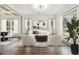 Inviting living room featuring a modern sofa, accent chairs, and large windows with natural light at 400 Stone Lea Trce, Oxford, GA 30054