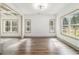 Bright living room with hardwood floors, neutral paint, modern lighting, and large windows at 400 Stone Lea Trce, Oxford, GA 30054