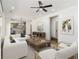 Open-concept living room boasts ample seating, natural light, and flows into the kitchen at 400 Stone Lea Trce, Oxford, GA 30054