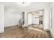 Bright open-concept living room featuring hardwood floors, modern lighting, and coffered ceiling detail in dining area at 400 Stone Lea Trce, Oxford, GA 30054