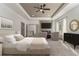 Comfortable main bedroom with fireplace, sitting area, decorative mirror, and plush carpet at 400 Stone Lea Trce, Oxford, GA 30054
