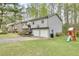 This charming two-story home has a large lawn and a swing set and slide set for entertainment at 175 W Station Nw Dr, Kennesaw, GA 30144