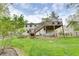 Backyard with a wooden deck, green lawn, and mature trees at 175 W Station Nw Dr, Kennesaw, GA 30144
