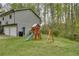 Backyard featuring a playset, a two-car garage, and a well-maintained lawn at 175 W Station Nw Dr, Kennesaw, GA 30144