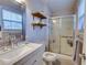 A bright bathroom with a glass enclosed shower, modern vanity and floating shelves at 175 W Station Nw Dr, Kennesaw, GA 30144