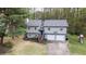 Two-story home with a two-car garage, a well-manicured lawn and mature trees at 175 W Station Nw Dr, Kennesaw, GA 30144