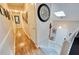 A beautiful hallway featuring hardwood floors, lots of art, and access to the staircase to the front door at 175 W Station Nw Dr, Kennesaw, GA 30144