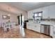 Bright kitchen and dining area with white cabinets, stainless steel appliances, hardwood floors, and natural light at 175 W Station Nw Dr, Kennesaw, GA 30144