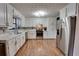 Stylish kitchen with stainless steel appliances, white cabinets, gorgeous countertops, and hardwood floors at 175 W Station Nw Dr, Kennesaw, GA 30144
