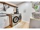 Well-equipped laundry room featuring modern washer, dryer, sink and storage cabinets at 175 W Station Nw Dr, Kennesaw, GA 30144