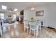 Open-concept living room with hardwood floors, fireplace, and dining area is filled with natural light at 175 W Station Nw Dr, Kennesaw, GA 30144