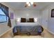 Comfortable main bedroom features a ceiling fan, wall paneling and a large window for plenty of light at 175 W Station Nw Dr, Kennesaw, GA 30144