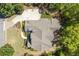 An overhead view of the house showing the landscaping, driveway, and backyard with wooded perimeter at 225 Ansley Close, Roswell, GA 30075