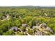 Aerial view of a beautiful home nestled among lush green trees in a serene, wooded neighborhood at 225 Ansley Close, Roswell, GA 30075