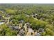 Aerial view of a neighborhood surrounded by mature trees, showcasing the home's location at 225 Ansley Close, Roswell, GA 30075